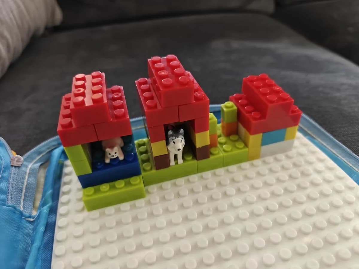 Customer photo of animal figures and brick buildings on a Brick Hero Case baseplate