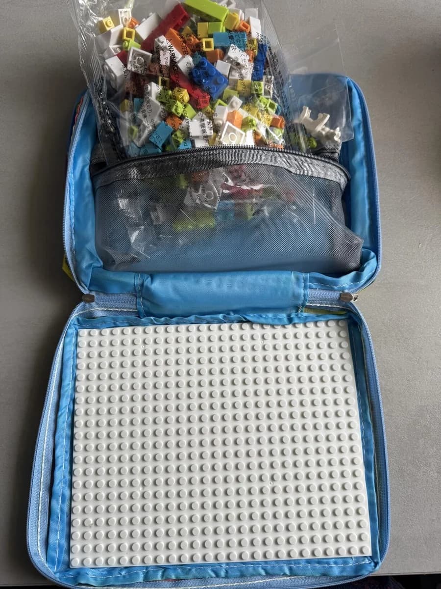 Customer photo of an open blue Brick Hero Case with bricks stored in the mesh pouch